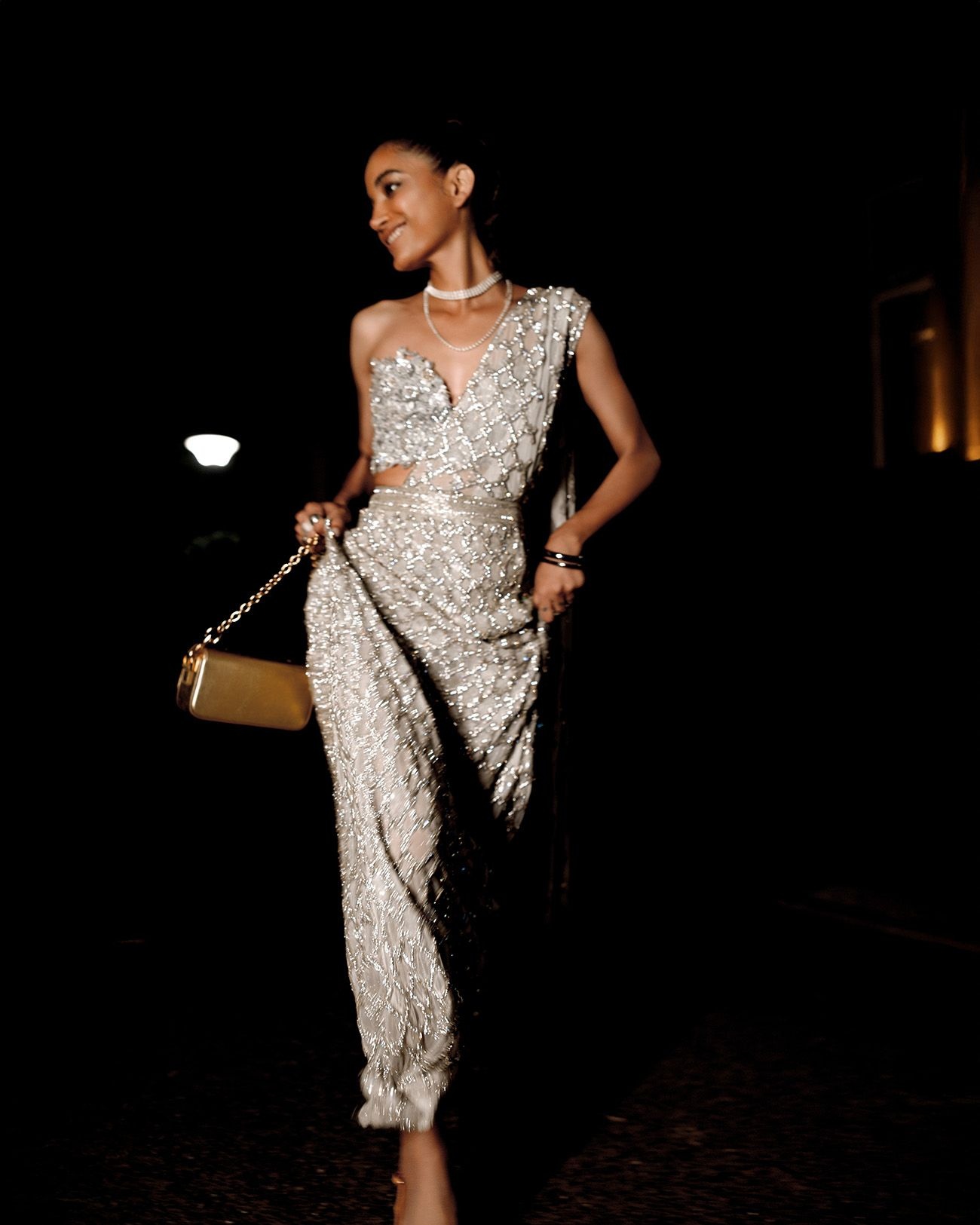 A model wearing the ‘Jharokha’ saree gown with ‘Himadri’ bustier top by Rahul Mishra and jewellery from Shop Lune