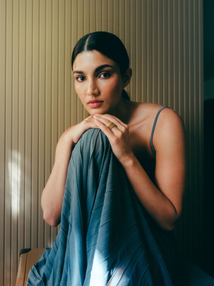 A close up of Alizeh in a strappy blue dress