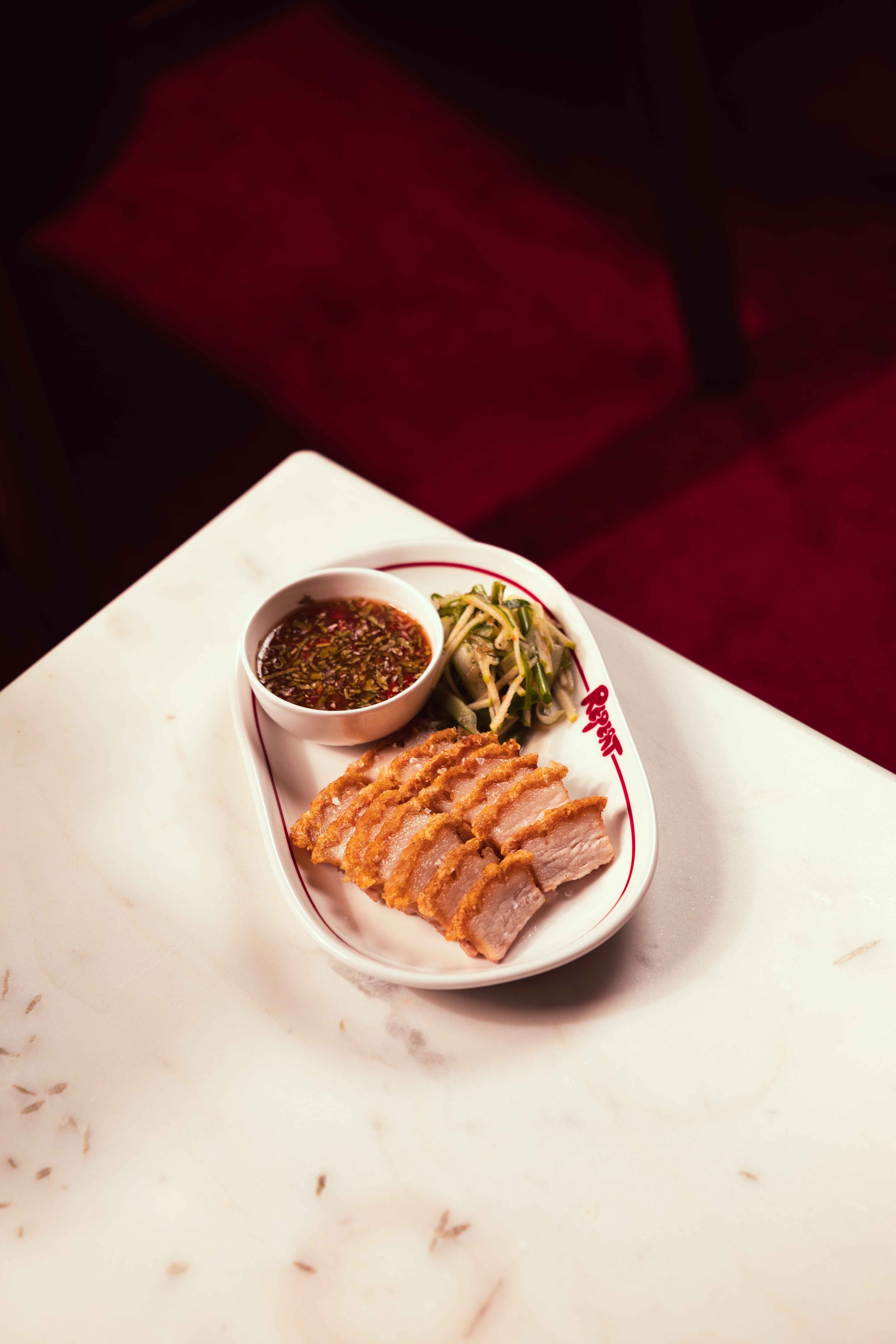 Crackling pork belly with green apple-scallion salad and curry mayo Repeat Kochi
