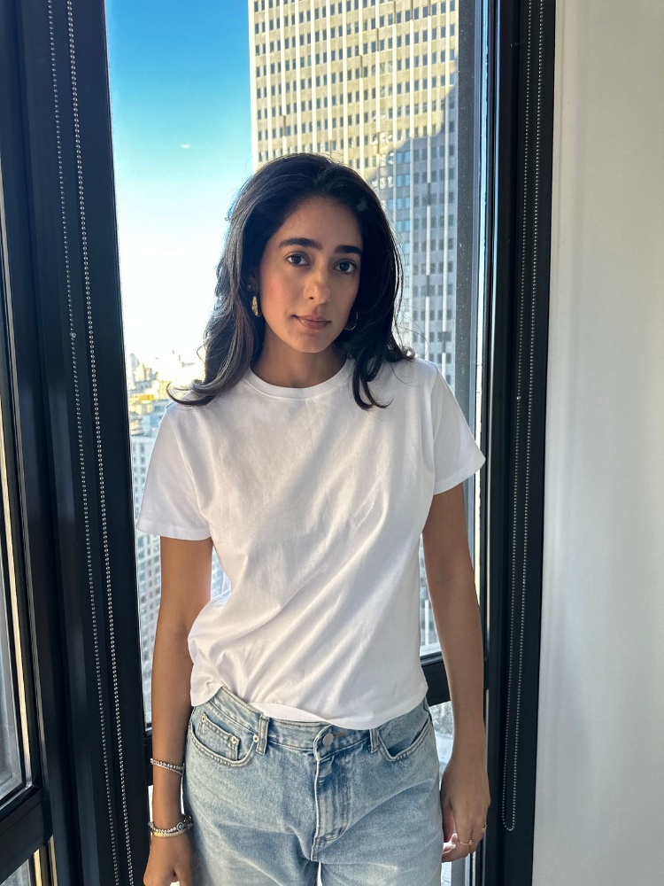 Diva Dhawan in a white T-shirt and blue jeans