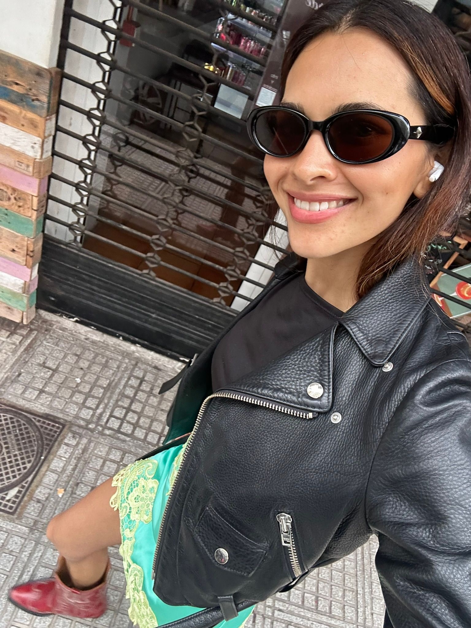 A selfie Karimah Hassan took on the go in a leather jacket, red cowboy boots, green silk skirt
