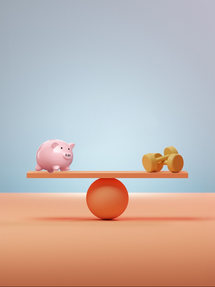 A scale with a piggy bank and dumbells