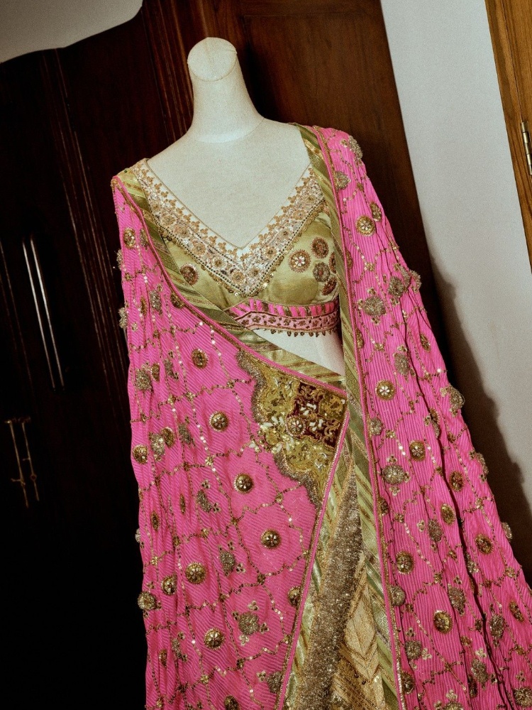 A pink and green lehenga by Pankaj Heritage