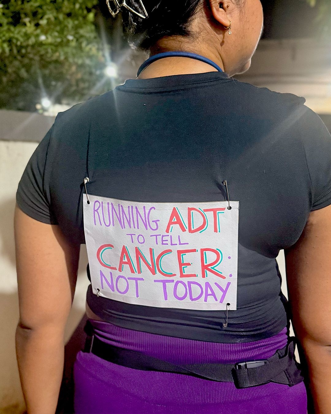 Nirikshya Patra at Nike's After Dark Tour wearing a bib that says "Running ADT to tell cancer not today", The Nod Mag
