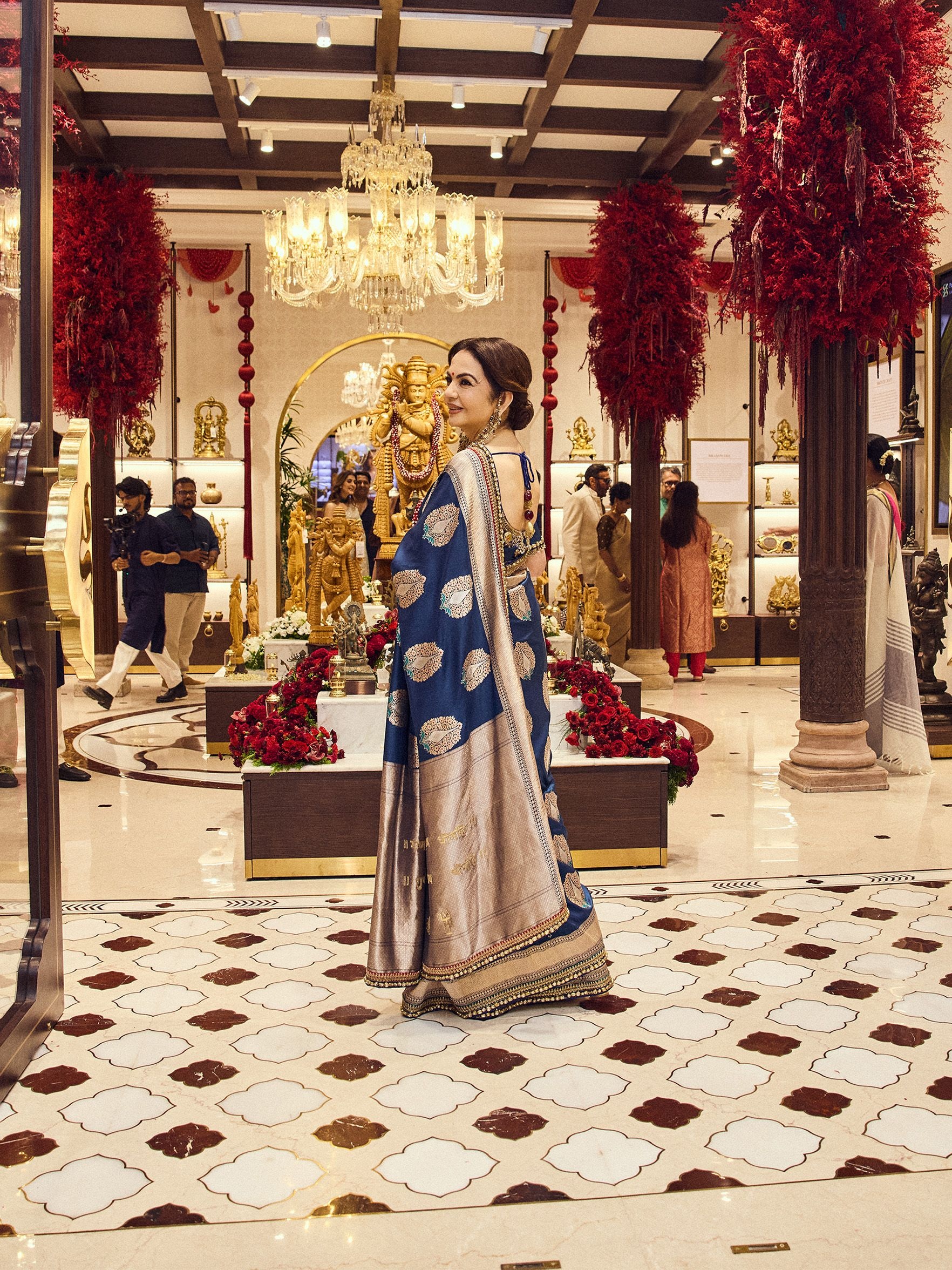 Nita Ambani wearing a peacock blue Banarasi saree from Swadesh