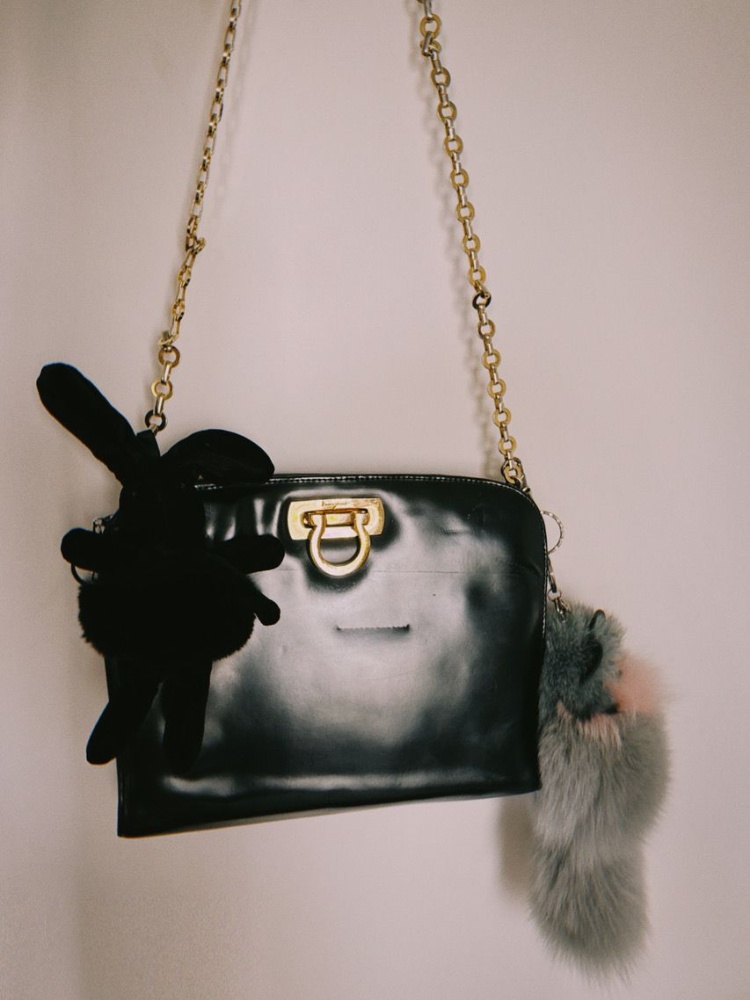 A vintage Ferragamo bag covered in plushie bag charms