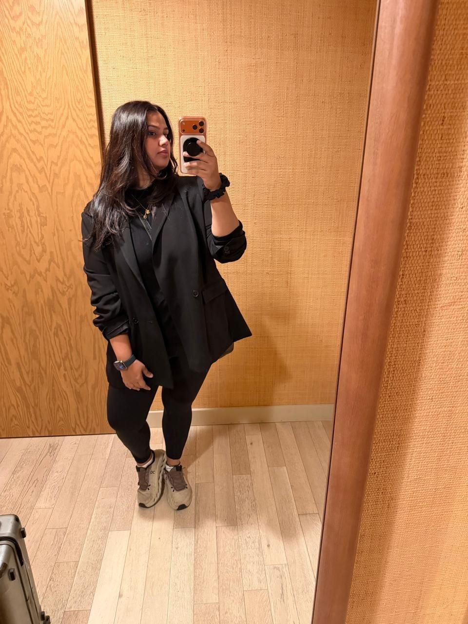 Chef and founder of Le 15 Pooja Dhingra in black Lululemon tights with an oversized blazer and sneakers