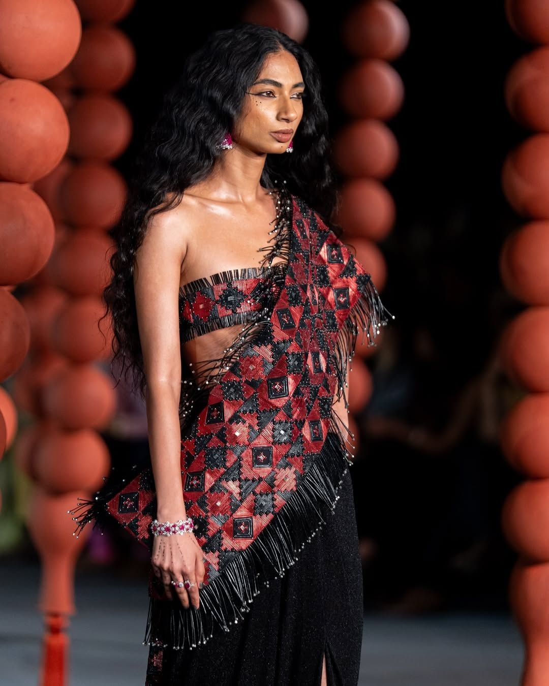 A red and black predraped sari look from Rimzim Dadu's Oxynn collection showcased at Hyundai India Couture Week 2025