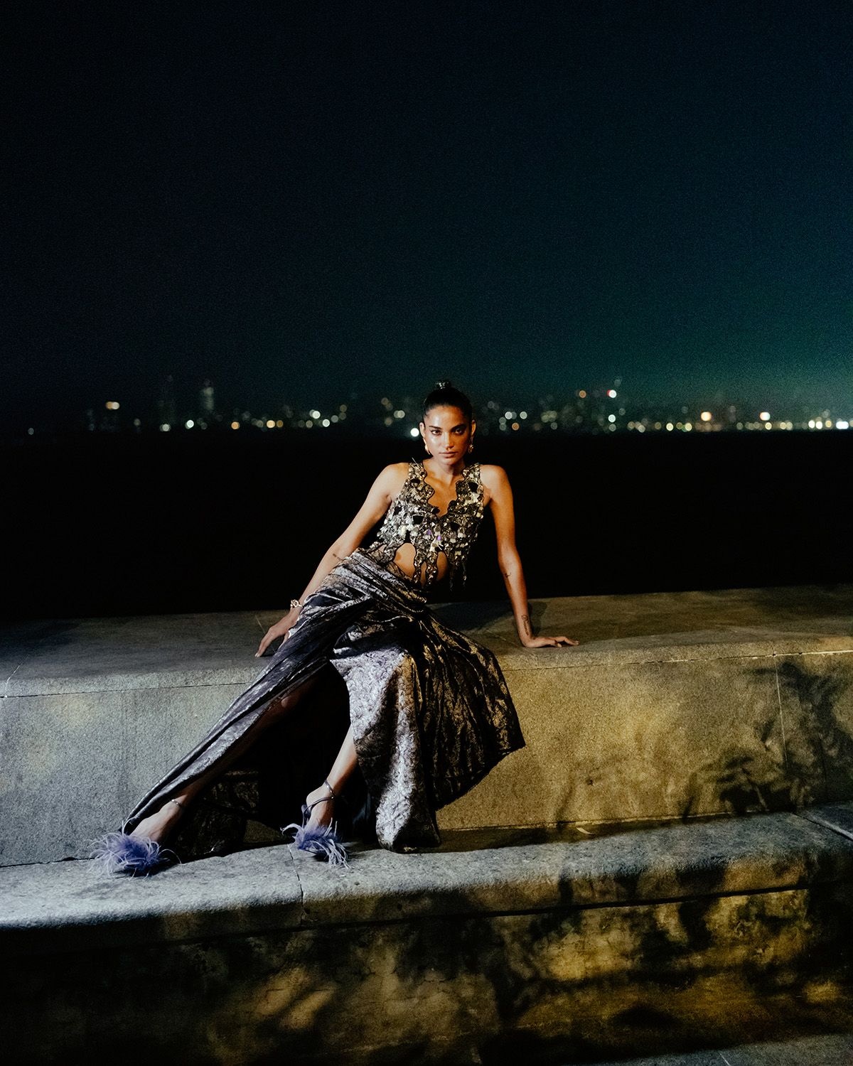 A model wearing a metal embellished blouse by Graine and an Ekaya X 431-88 sari with feather heels from Christian Louboutin
