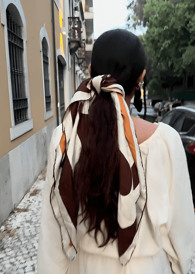 Stylist and creative director of Bodements Divya Saini wearing a Burberry scarf as a hairtie