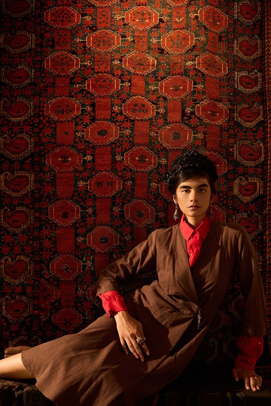  18th-century Bashir rug with pomegranate motifs from West Turkestan’s Amu Darya region. On Anika: Payal Pratap shirt; 11.11/eleven eleven dress; Pepper Coin jewellery