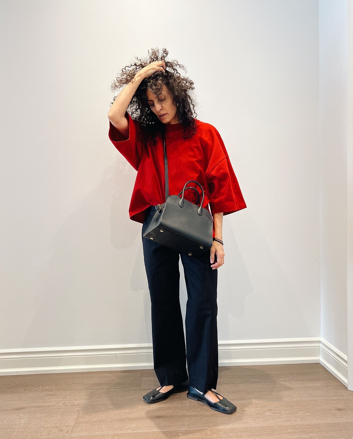 Neelam Ahooja in The Row Issi top, Henry cropped pants, T-Strap sandals, and Margaux 10 bag