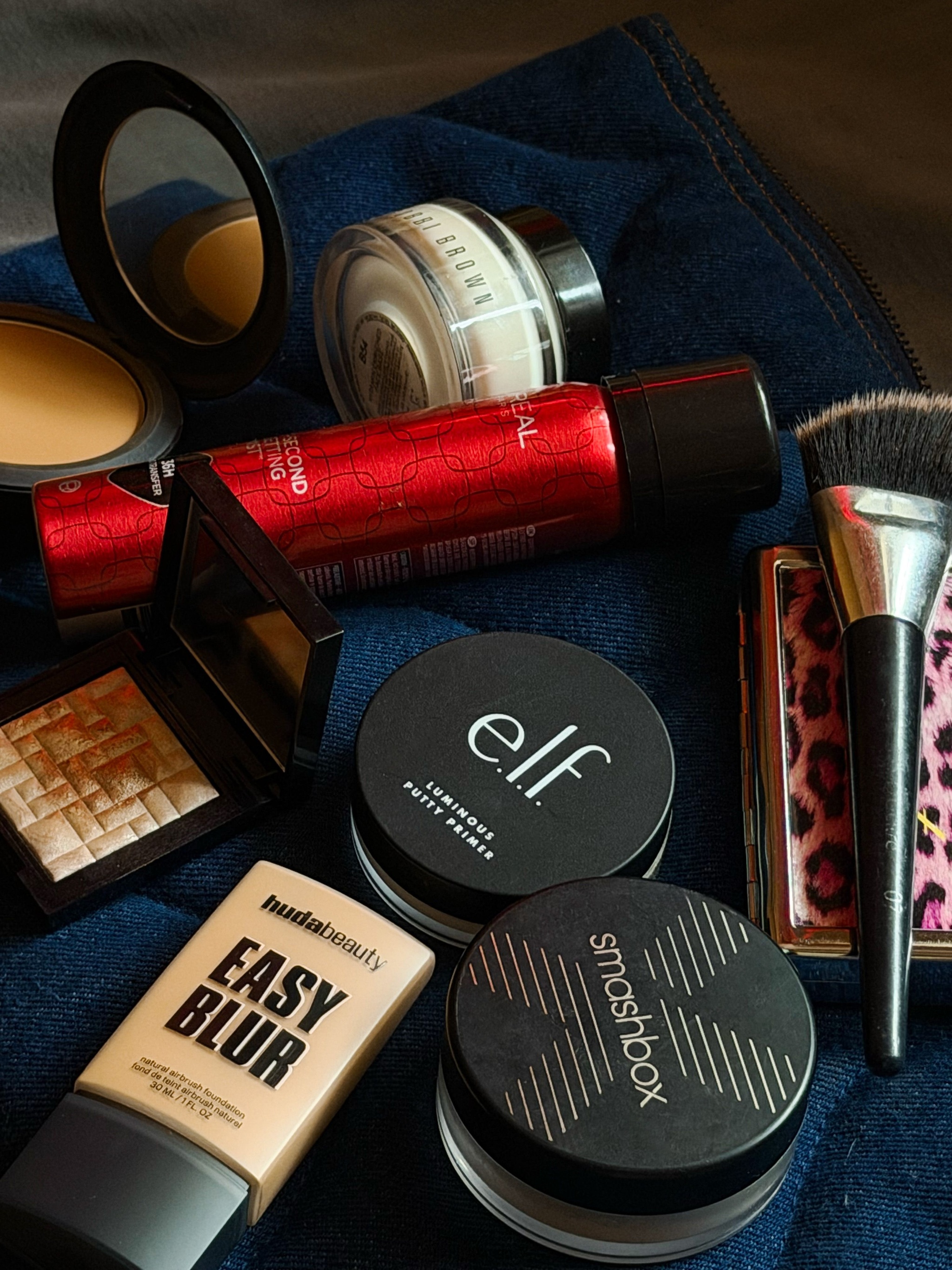 In Christopher's emergency beauty festive kit: Elf's Clear Brow and Lash mascara and Putty primer, L'Oréal Paris Infaillible 3-Second setting mist and highlighters galore