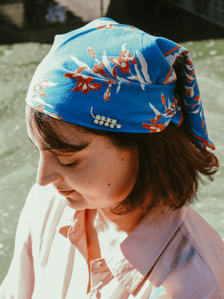 A Sigla sprig brooch styled on a Bandana