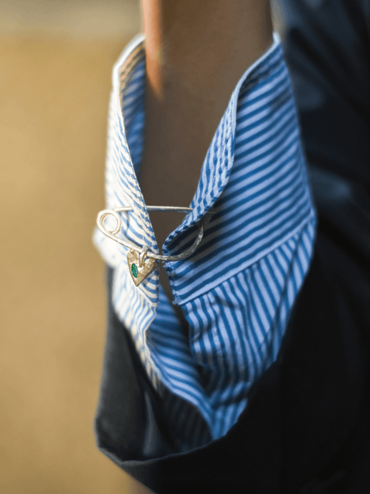 The Ouze XL heart brooch on a shirt cuff
