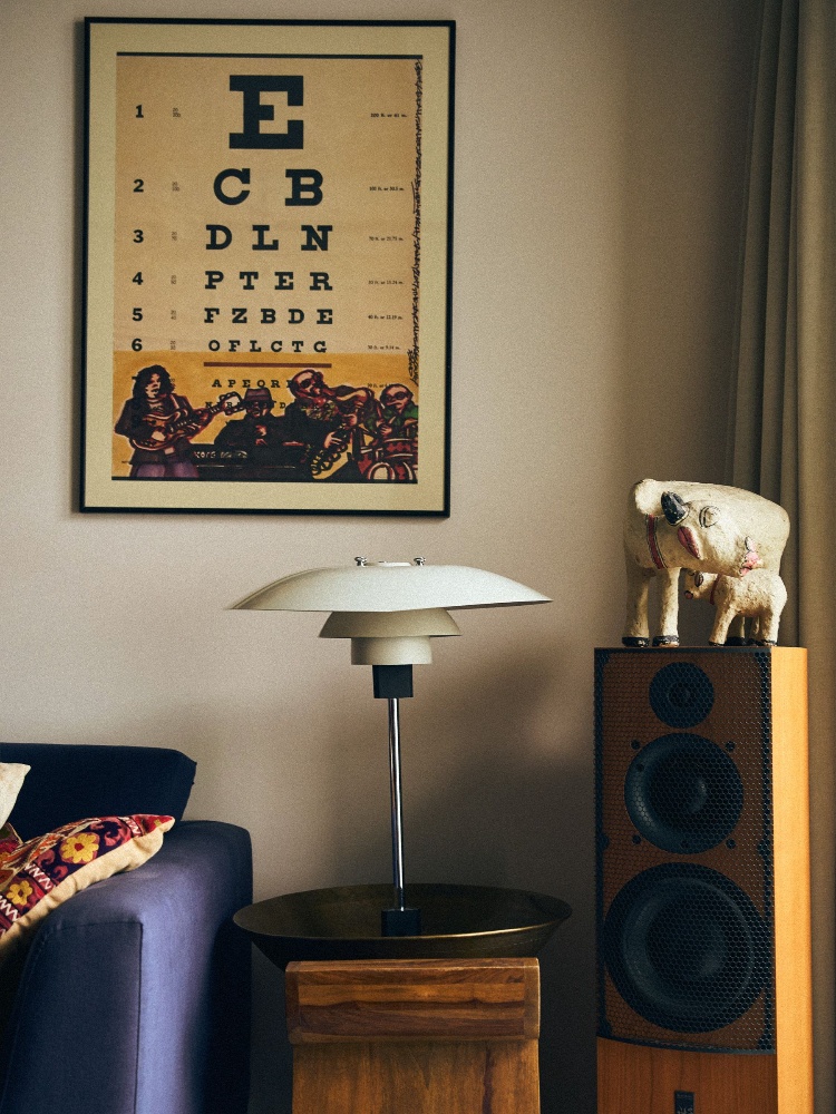 A lamp by Poul Henningsen accents the space