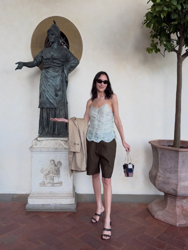 Alexa Chung in a pair of olive Bermuda shorts from Khaite