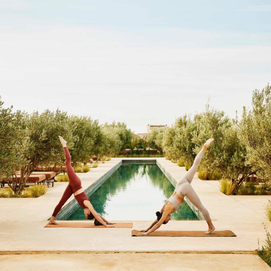 Women doing yoga at a wellness retreat - The Nod