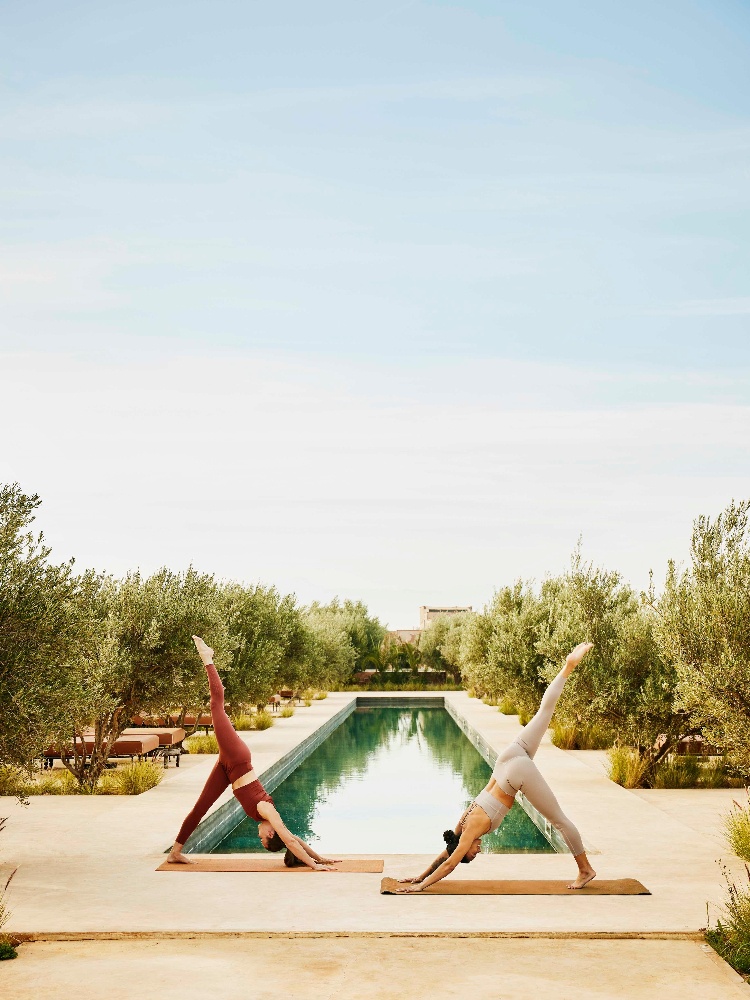 Women doing yoga at a wellness retreat - The Nod
