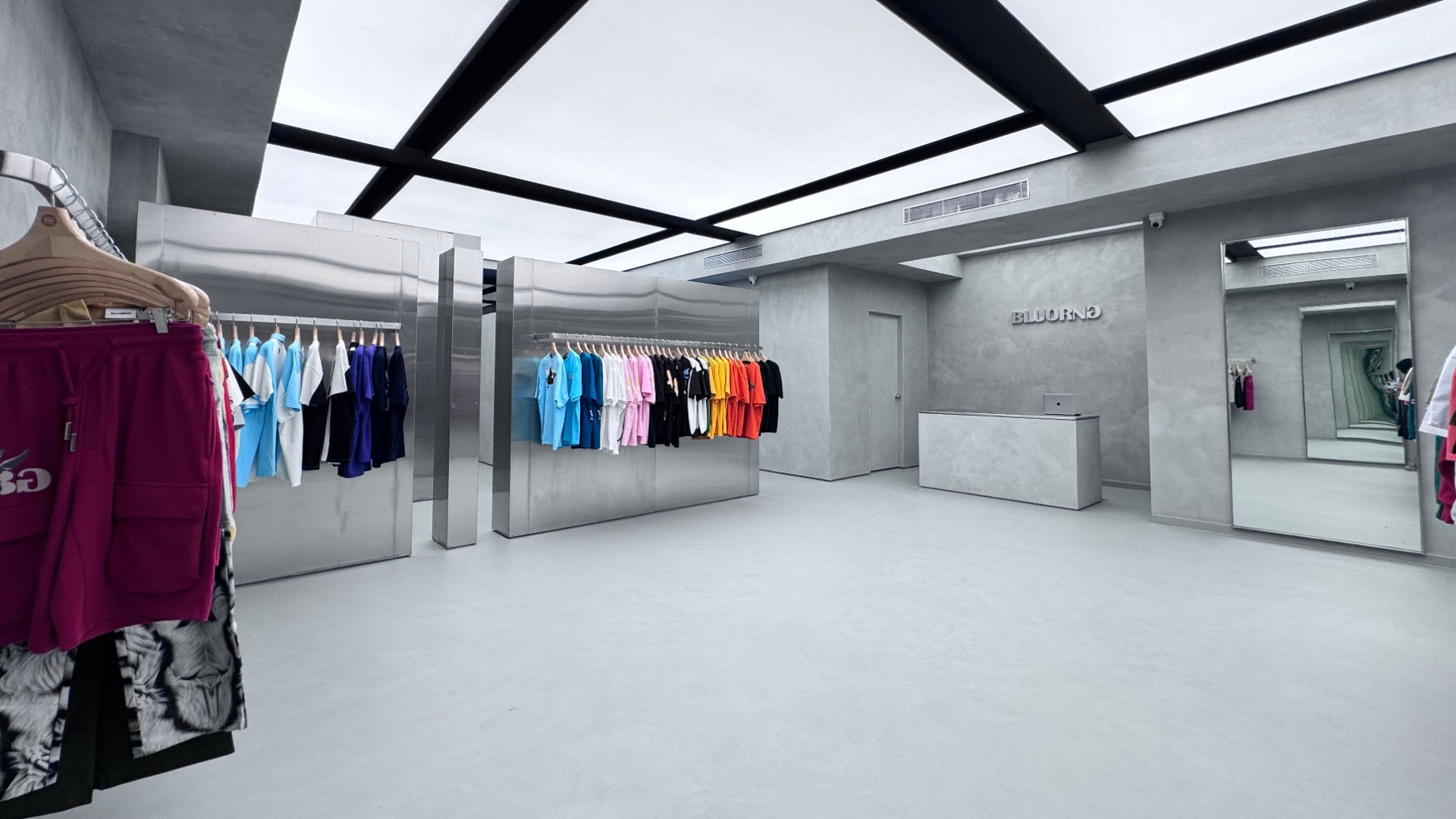 Bluorng’s garments punctuate the grey-and-steel palette with colour