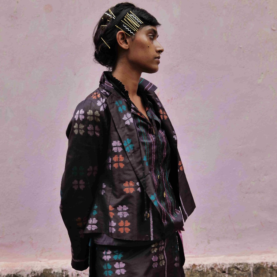 A model wearing a black Khandua silk jacket with floral motifs
