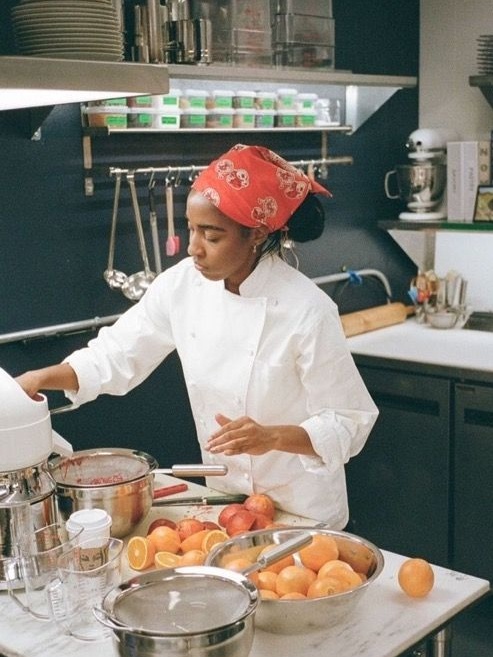 Ayo Edebiri as chef Sydney Adamu in The Bear in a kitchen