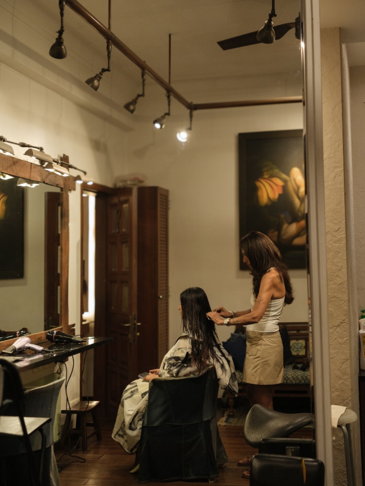 Clarabelle Saldanha cutting a client's hair in her private salon in Bandra
