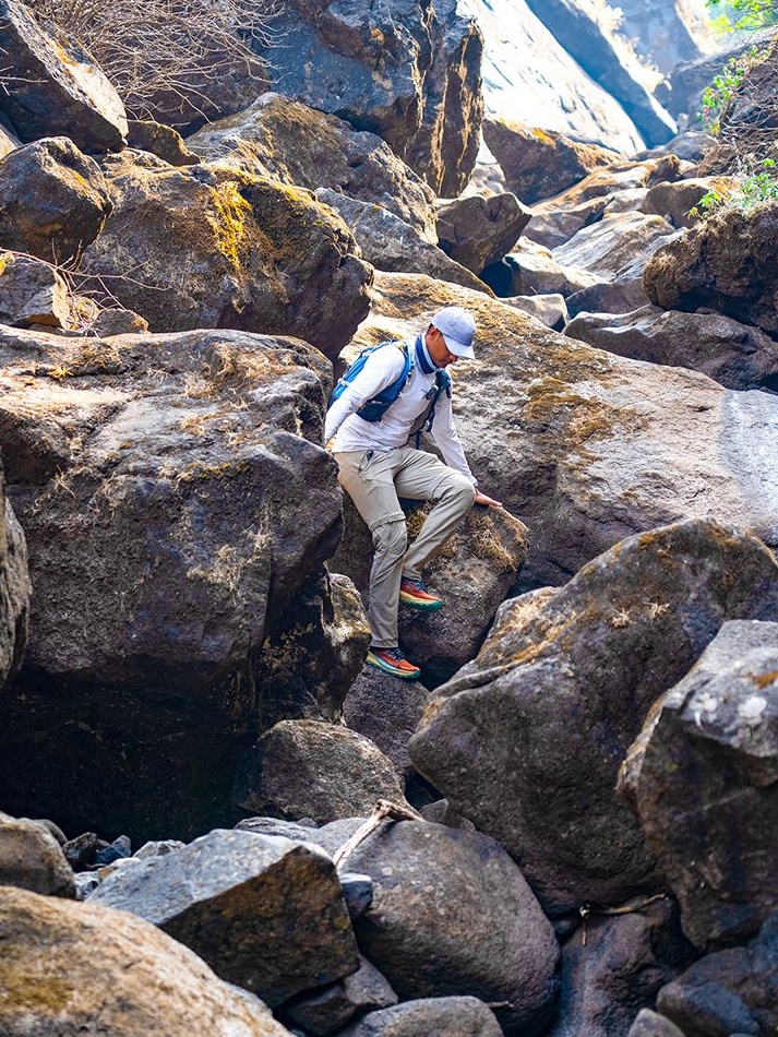 Shekhawat climbing down boulders