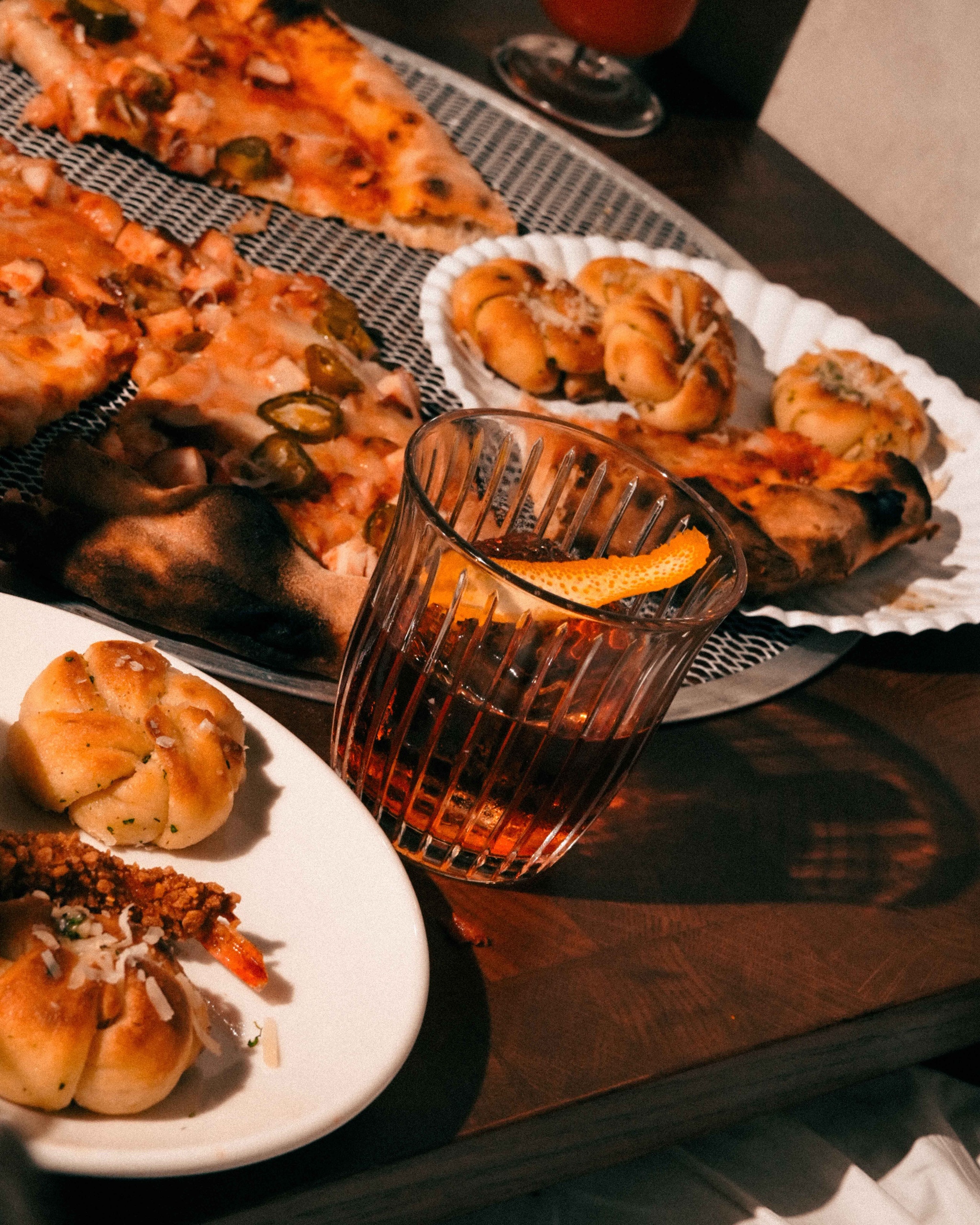 Garlic knots and pizza pies with an old fashioned cocktail