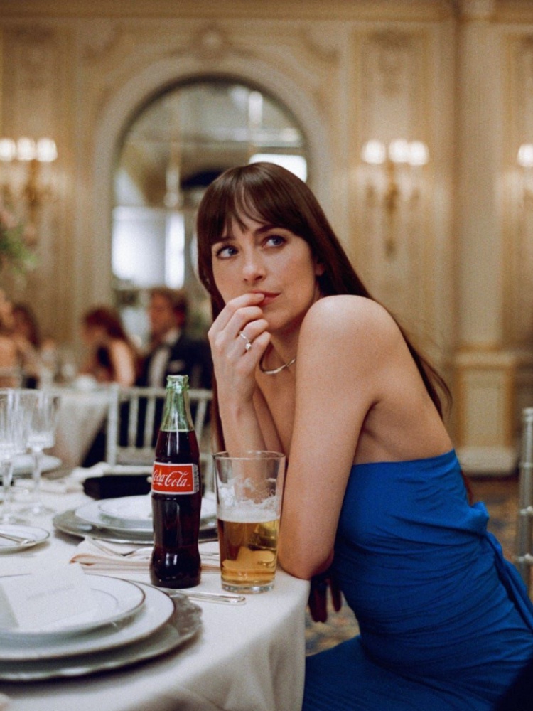 Dakota Johnson in Materialists wearing a blue dress with silver jewellery