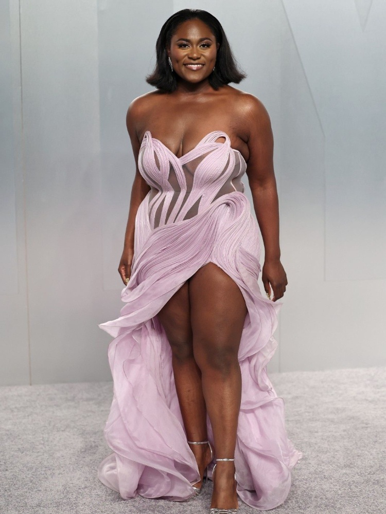 Danielle Brooks in a lilac Gaurav Gupta gown with a sheer bodice and a leg slit at the Vanity Fair Oscar party