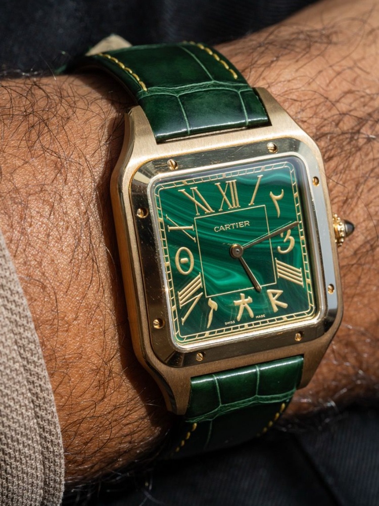 Dillon Bhatt wears a Cartier Santos Dumont XL "TimePeace" NSO. The dial includes numerals from different alphabets, including Arabic, Hebrew and Mandarin.