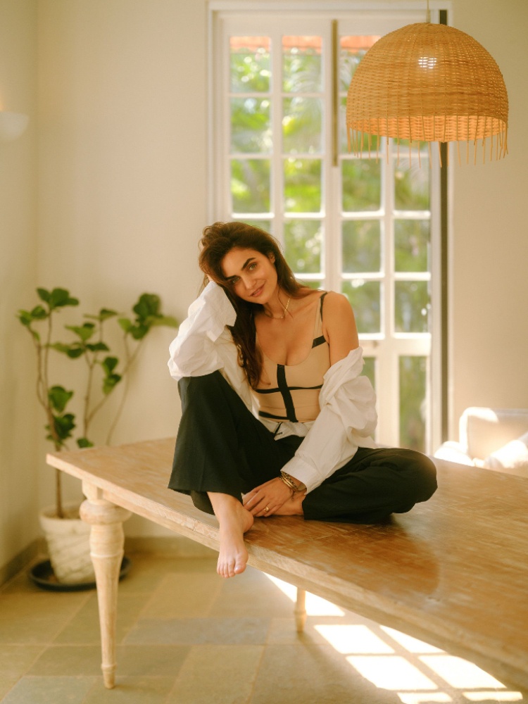 Gabriella Demetriades in a Nanushka shirt, Toteme swimsuit, and The Frankie Shop trousers in Goa