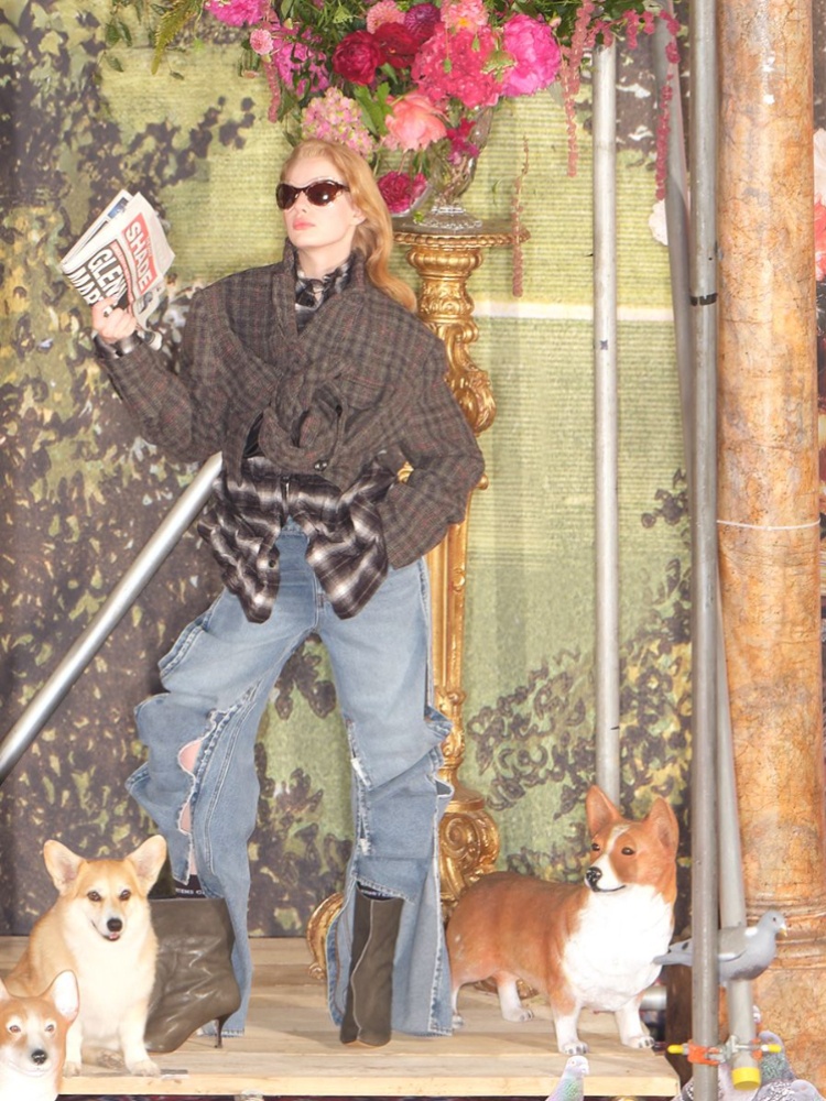 A model wearing scrunched up shirts, jeans and boots from the H&M Glenn Martens Collection