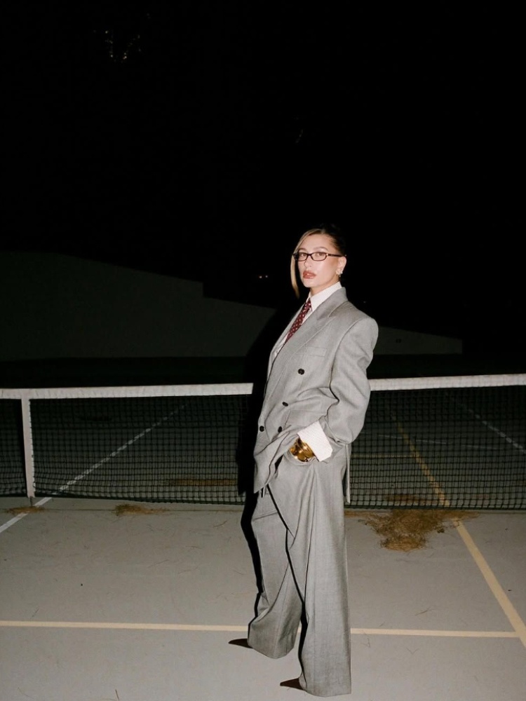 Hailey Bieber in an oversized grey suit by Anthony Vaccarello for Saint Laurent