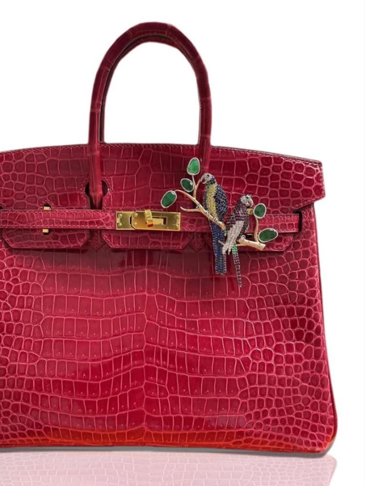 A crocodile Hermès Birkin adorned with jewellery