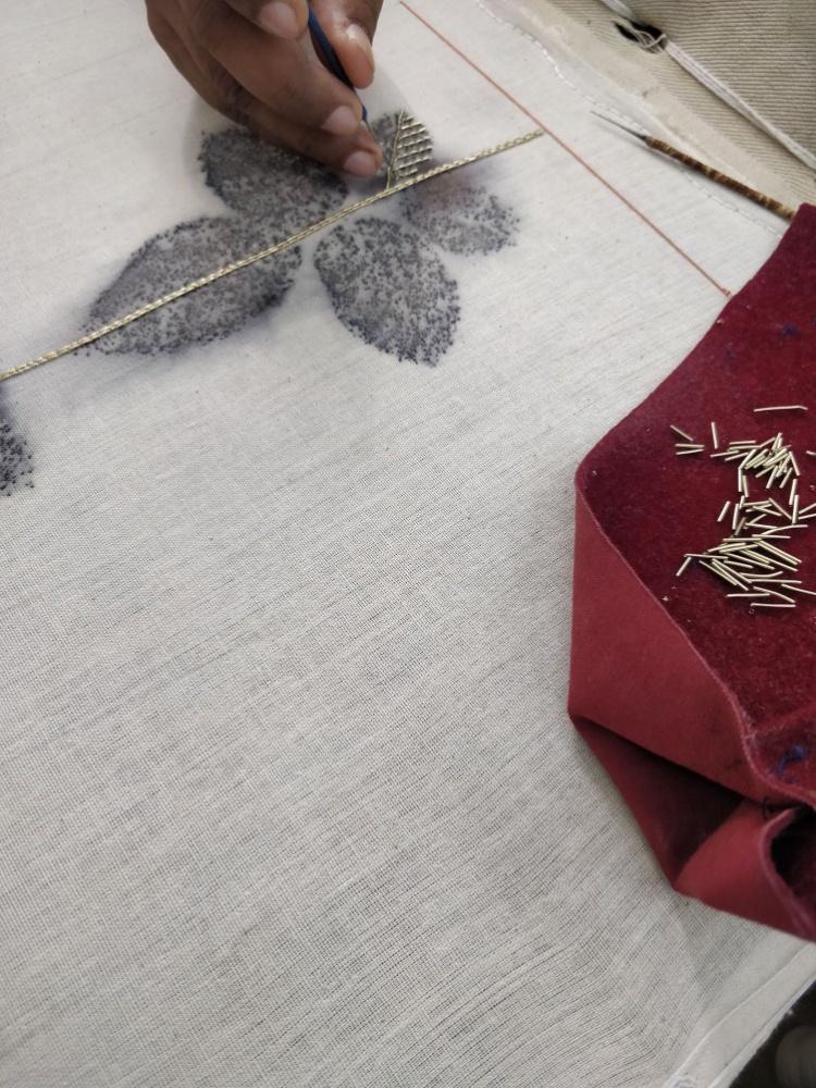 A hand embroidering a ghaghra