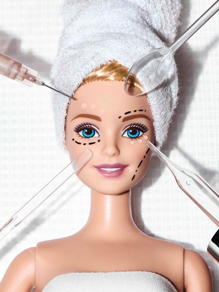 A barbie getting injectables