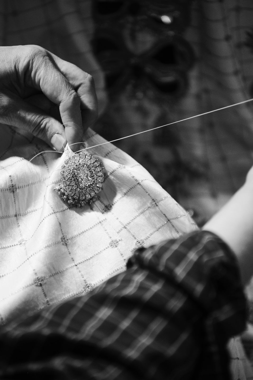 Jewels being sewn onto Isha Ambani's Anamika Khanna outfit for the 2025 Met Gala