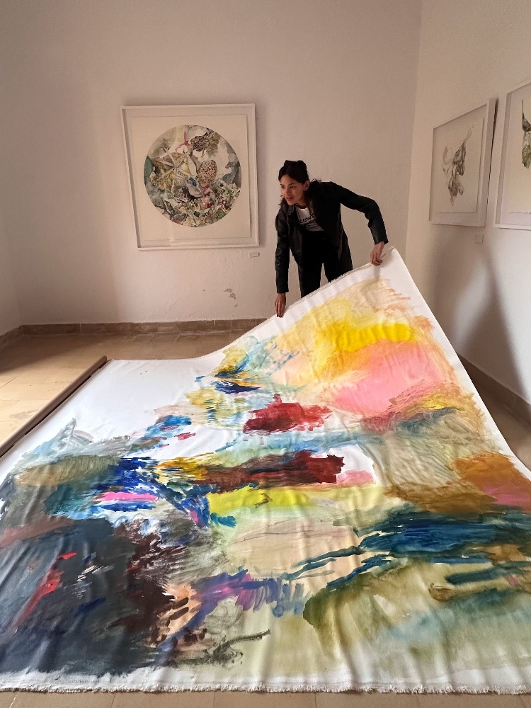 Artist Karimah Hassan in her studio wearing a leather jacket