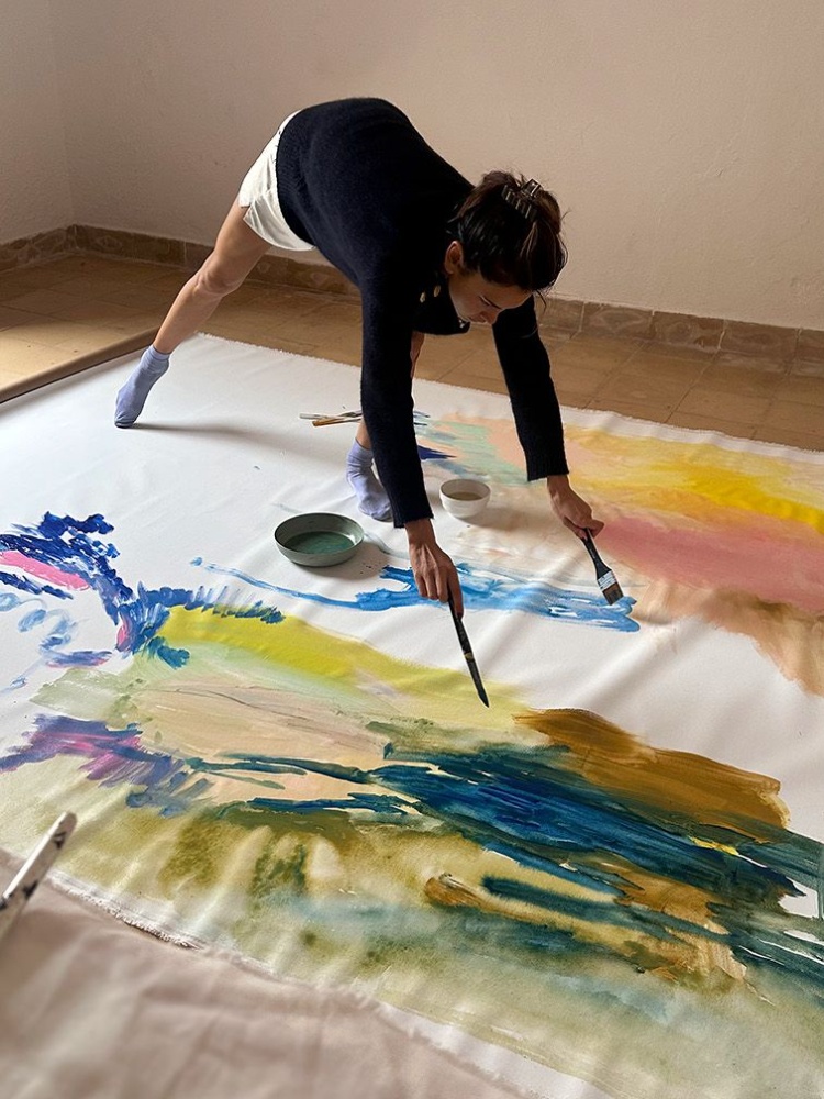 Artist Karimah Hassan painting in her studio