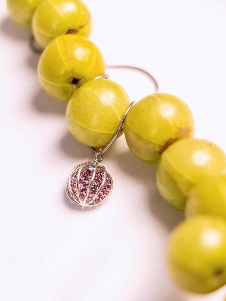 Unique silver jewellery by Maison Megh. Pictured here: Amla pendant with garnets