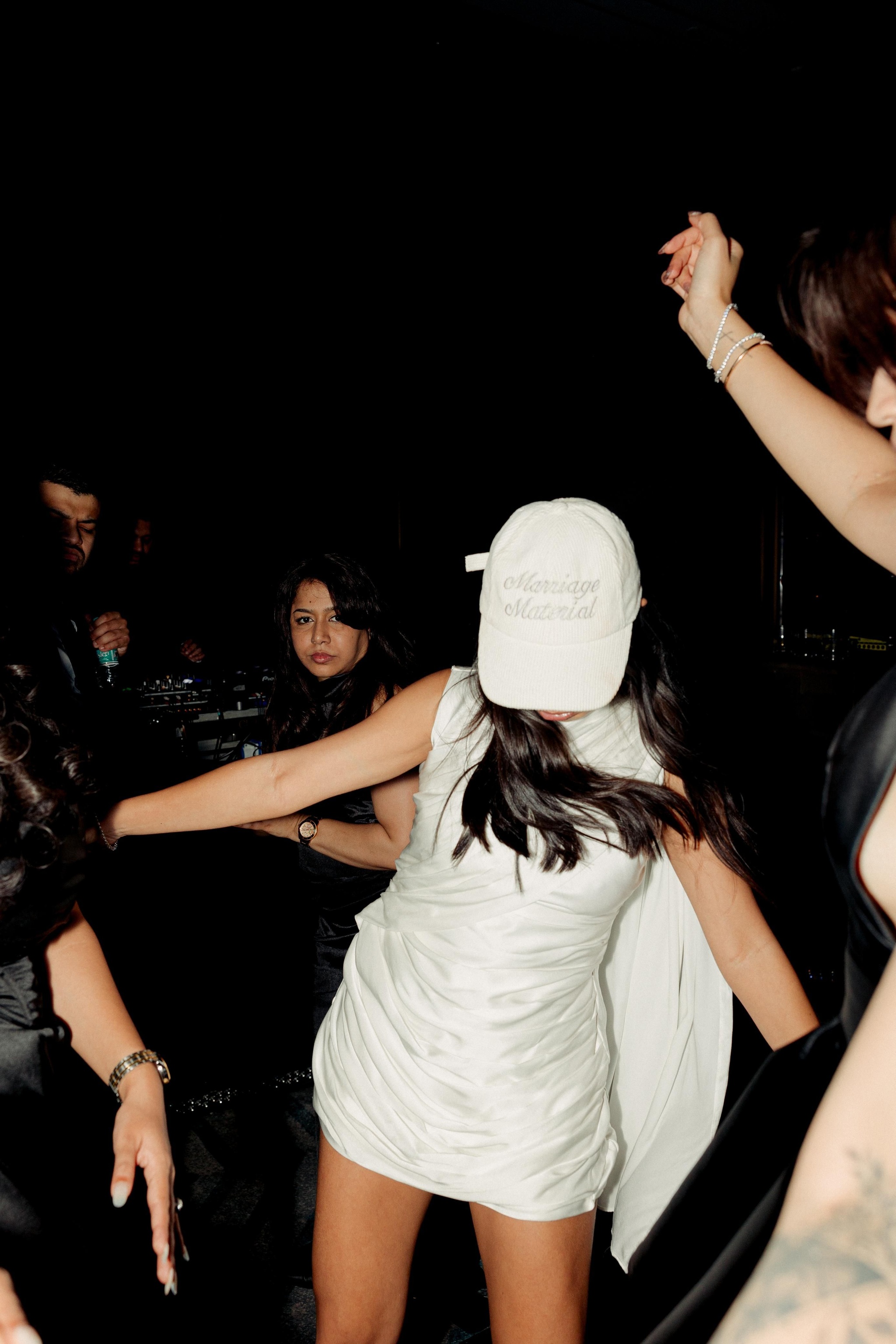 Meagan Concessio's wedding after party look was a Gundi Studios dress, Nike Air Force 1s, and custom made cap