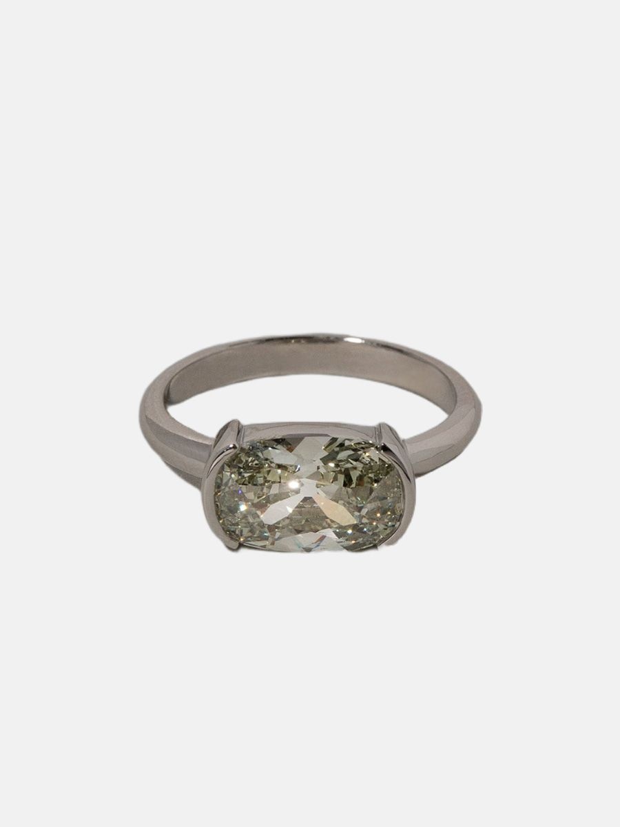 Mociun Shift ring featuring a greenish oval diamond in east west setting