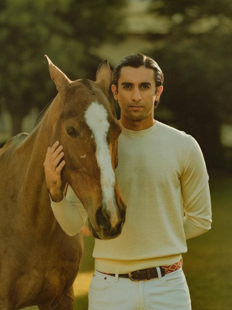 Pacho (Sawai Padmanabh Singh) in a light knit sweater with a horse