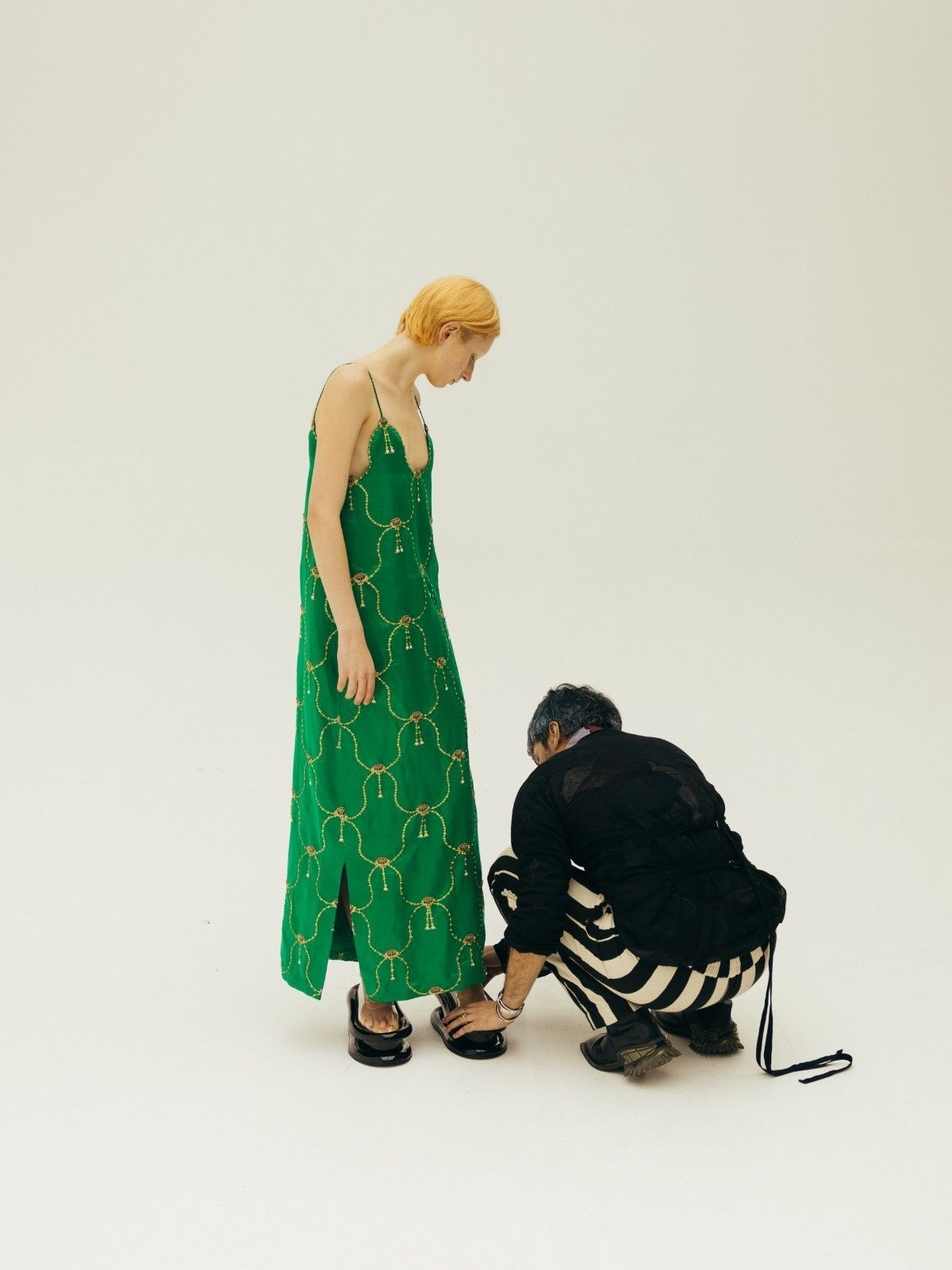 A green Raw Mango brocade dress being fitted before the brand's London Fashion Week show
