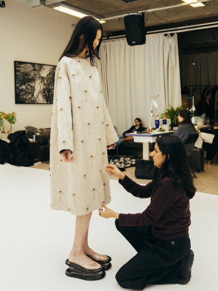 A white Banarsi silk brocade dress being fitted before Raw Mango's London Fashion Week Show