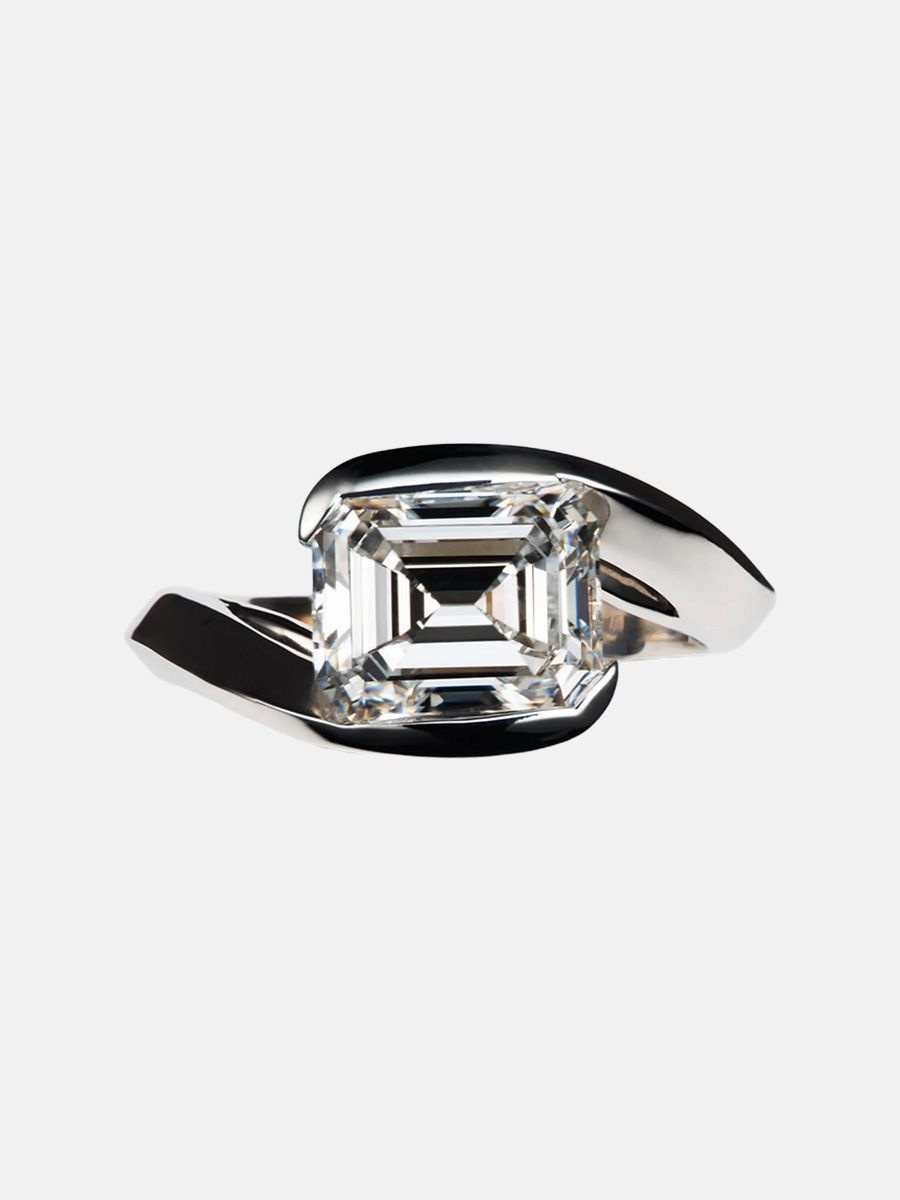 Reza A ring featuring an emerald cut diamond in east-west setting