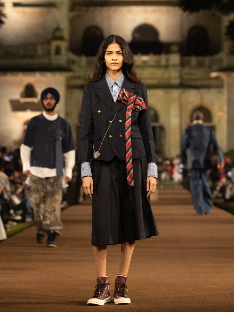 A model on the Rkive City X Mayo College runway wearing Converse