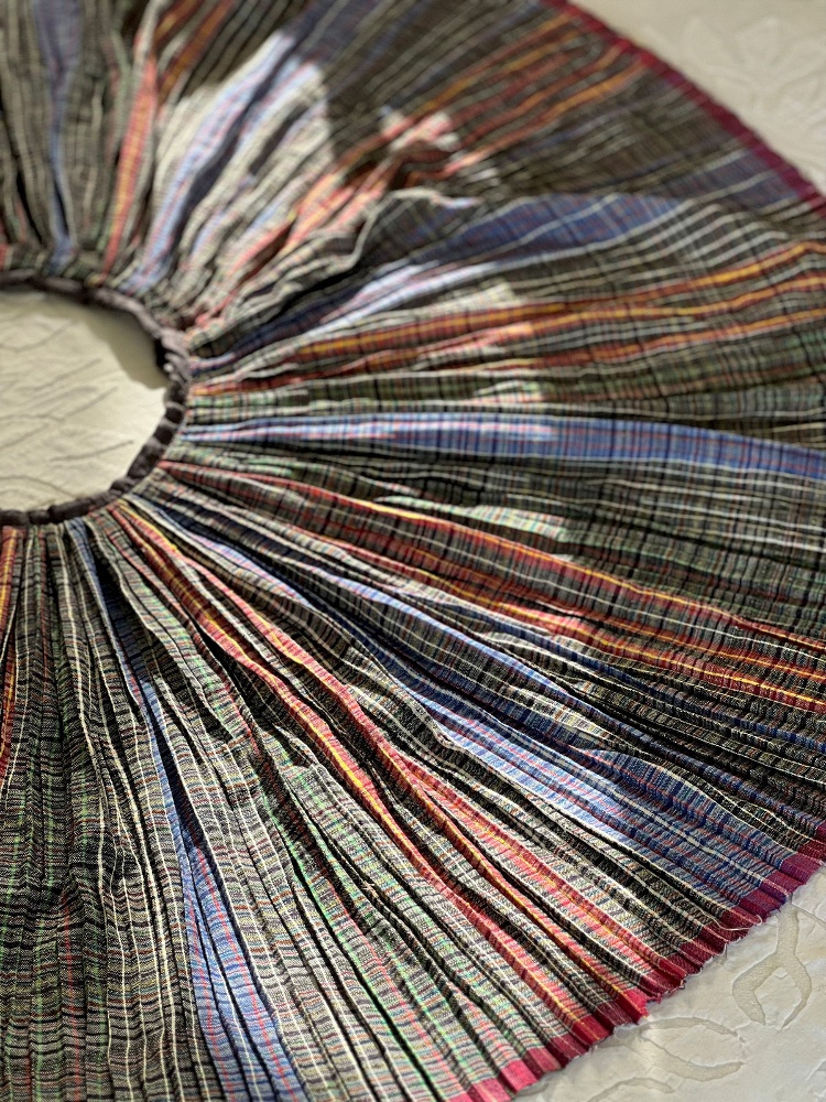 Close up of a micro-pleated gamcha skirt by Moving Parts